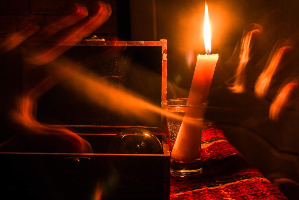 Faelorin Lit Smoking Candle with Small Chest Open with Crystal Ball inside in Dim Light Lit Smoking Candle with Small Chest Open with Crystal Ball inside in Dim Light